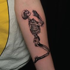 a man with a skeleton tattoo on his arm