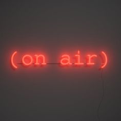 a red neon sign that says on air