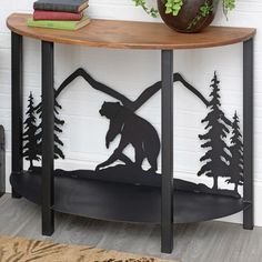 a table with a bear and trees cutout on it next to a potted plant