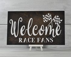 a wooden sign that says welcome race fans