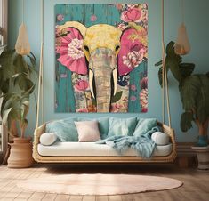 an elephant is painted on the wall next to a couch and potted plant in front of it