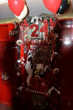 the locker is decorated with balloons, streamers and other decorations for someone's 21st birthday