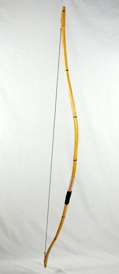 a wooden bow and arrow on a white background