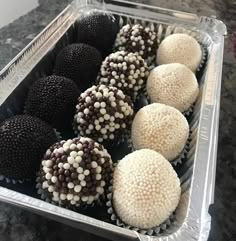 there are many different types of chocolates in the tray on the counter top together