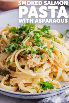 a white plate topped with pasta covered in parmesan cheese and garnished with parsley