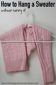 a pink sweater hanging on a white hanger with the words how to hang a sweater without running it