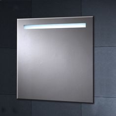 a bathroom mirror with lights on it and a wall mounted light above the mirror in front of it