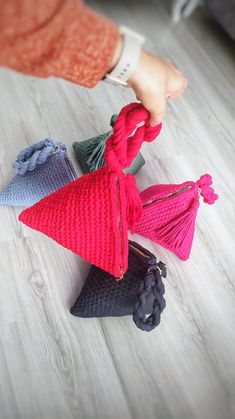 a person is pulling the ends of several pieces of knitted material