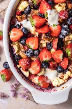 a bowl filled with fruit and cereal on top of a table