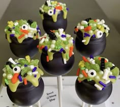 there are many halloween candies on top of the cake popss that look like they have googly eyes