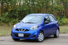 a small blue car parked in a parking lot