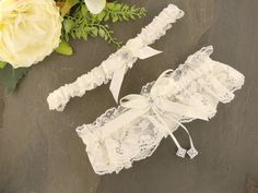 Make a stunning statement with our Elegant White Guipure Crochet Lace Garter. Handcrafted with care, this garter features beautiful white guipure crochet lace adorned with a satin black ribbon, black feathers, and iridescent stones. The contrasting colors and textures create a captivating and glamorous design. Whether you're looking to enhance your bridal ensemble or add a touch of elegance to special occasions, this garter is the perfect accessory. The white guipure crochet lace exudes a classi Bridal Garter Lace, Nottingham Lace, Wedding Garter Lace, Lace Garter, Bridal Garter, Wedding Garter, Black Feathers, Black Ribbon, Bridal Lace