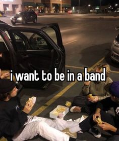 some people sitting on the ground eating food