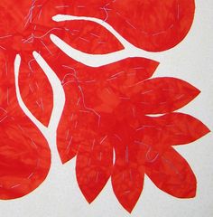 a red piece of paper with leaves on it