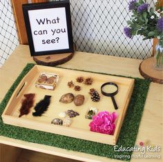 a wooden tray filled with lots of different types of items on top of a table