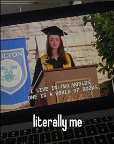 a woman in graduation cap and gown giving a speech on a laptop screen with the caption i live in two words, one is a world of books