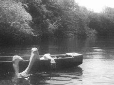 a woman in a boat floating on top of water