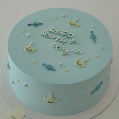 there is a blue cake that says happy birthday to you on the top and stars around it