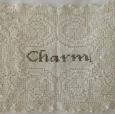 an old white cloth with the word charm written on it