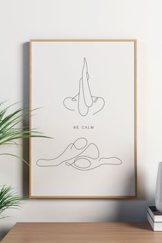 a minimalist poster with the words be calm on it in front of a plant