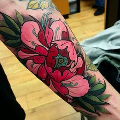 a person with a flower tattoo on their arm