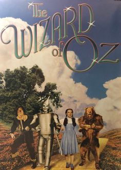 the wizard of oz movie poster with three people dressed as wizard and wizard in costume