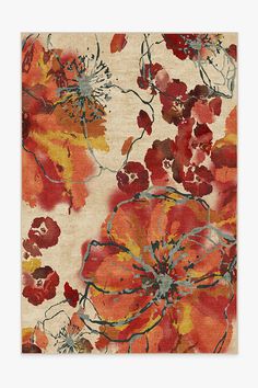 an orange and red rug with flowers on it