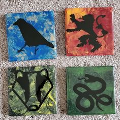 four square paintings with animals and letters on them sitting on the floor next to each other