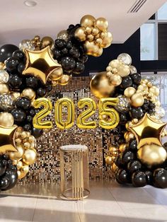 the entrance to an office decorated with balloons and gold foil stars for new year's eve