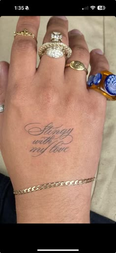 a woman's hand with two rings on it and the words happy birthday to her