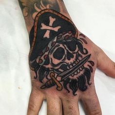 a hand with a skull and cross on it