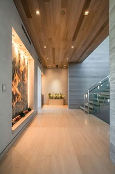 an empty room with wooden ceiling and planters on the wall, along with glass balconies