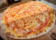 a pizza sitting on top of a wooden cutting board