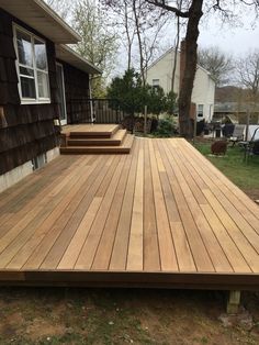 a wooden deck in front of a house