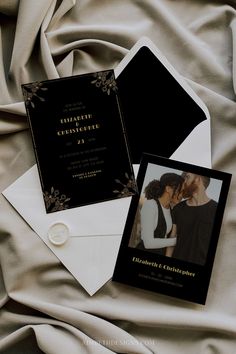 two black and white wedding cards on top of an envelope with the same photo in it