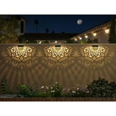 an outdoor wall light with decorative lights on it