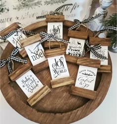 small wooden tags tied with black and white ribbon on top of a wooden tray filled with cards