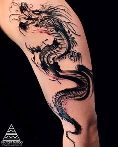 a dragon tattoo on the leg of a person's leg, with black ink