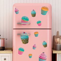 a pink refrigerator with cupcakes painted on it