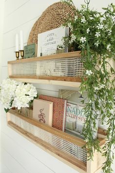 two wooden shelves with books and flowers on them