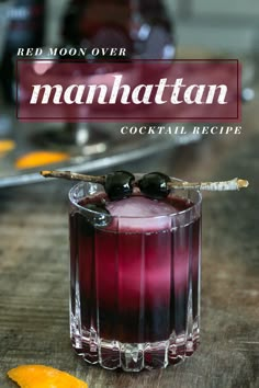 the manhattan cocktail is garnished with an orange slice and black olives on top