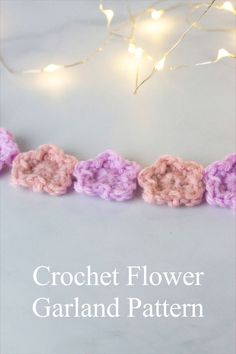 the crochet flower garland pattern is shown in pink, purple and white yarn