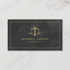 a law business card with a gold scale and scales on the front, black background