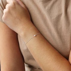 Dainty and classic, our Aura tiny pearl bracelet is a beautiful piece to wear everyday. Simple and timeless, you can wear it with everything.  P R O D U C T * D E T A I L S  - Pearl measures approximately 3.5mm - Available in Sterling Silver, 14k Gold Filled and 14k Rose Gold Filled - Each freshwater pearl is unique meaning the size and shape may vary - Wire wrapping detail - Available in Sterling Silver, 14k Gold Filled and 14K Rose Gold Filled L E N G T H - This bracelet is measured opened fro Dainty Silver Bracelet With Pearl Chain, Dainty Sterling Silver Bracelets With Pearl Charm, Everyday Delicate Sterling Silver Pearl Bracelet, Minimalist Sterling Silver Pearl Bracelet, Minimalist Silver Pearl Bracelet For Everyday, Minimalist Everyday Silver Pearl Bracelet, Everyday Minimalist Silver Pearl Bracelet, Dainty Silver Bracelet With Pearl Drop, Delicate Silver Pearl Bracelet For Everyday