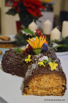 two pieces of cake sitting on top of a white plate covered in frosting and flowers