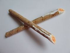 a cross made out of crackers on a white surface with an orange peel in the middle