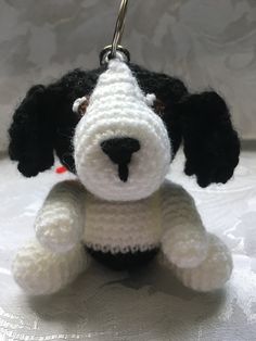 a crocheted dog keychain with a black and white puppy on it