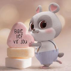 a small toy mouse holding a heart shaped lollipop with the words bake life vir you written on it