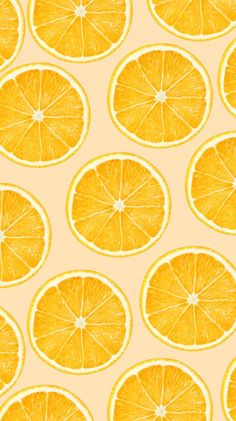 an orange is cut in half on a yellow background