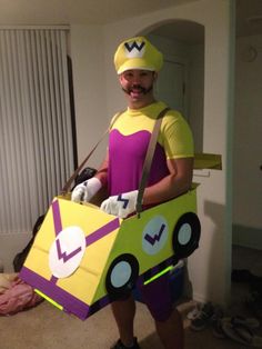 a man in a costume that is holding a cardboard box with a car on it